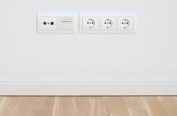 Wall in modern appartment with plugs for TV and radio, internet, network and electricity.